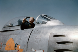 Aldrin in a cockpit with canopy pulled back
