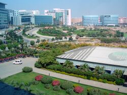 City panorama showing gardens, clean roads and modern office buildings