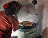 Woman cooking bread on an electric stove