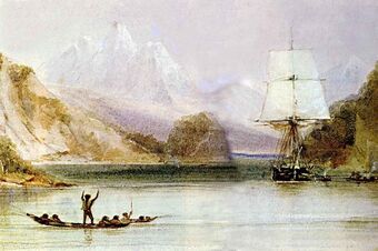 On a sea inlet surrounded by steep hills, with high snow-covered mountains in the distance, someone standing in an open canoe waves at a square-rigged sailing ship, seen from the front