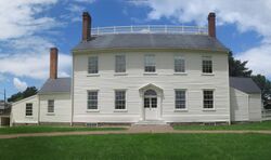 Photograph of a two-story, white clapboard house