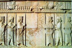 Stone relief depicting two groups of three men facing each other