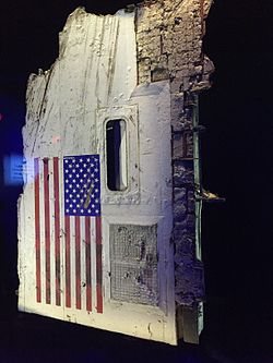 A portion of the Challenger's fuselage hanging vertically, displaying the American flag.