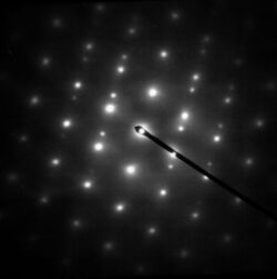 Electron diffraction pattern showing white spots on a dark background, as a general example.