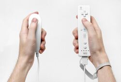 Two types of Wii controllers, one in each hand