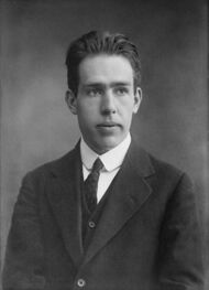 Head and shoulders of a young man in a suit and tie