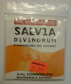 A rectangular plastic re-sealable zipper storage bag that appears to be approximately 10 by 15 centimeters. The bag has a white label and a large wavy orange stripe. The top of the label reads: "THE STANDARDIZED SALVIA DIVINORUM" in large letters and "STANDARDIZED 20X EXTRACT" in smaller letters immediately below. The bottom of the label reads "8 mg STANDARDIZED SALVINORIN-A EXTRACT" in small letters. Affixed to the bag is an orange price tag reading "SPECIAL $5.99."