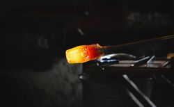 A red hot piece of glass being blown