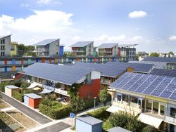 Short terraces of houses, with their entire sloping roofs covered with solar panels
