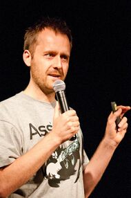 Man in a T-shirt giving a talk