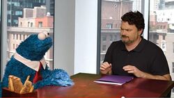 Double Fine Productions owner Tim Schafer and the character Cookie Monster during a promotional video for Sesame Street: Once Upon a Monster