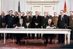 Carter and Brezhnev sitting next to each other.