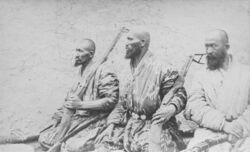 Photo of three bearded, armed men