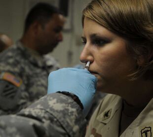 GI receives an intranasal mist of the flu vaccine at Guantanamo.jpg