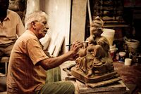 Man painting a Murti of Ganesh