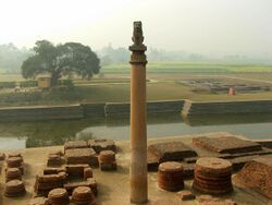 Stone pillar in front of a river